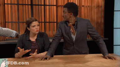 Man And Woman Sitting At Table With Hands GIF