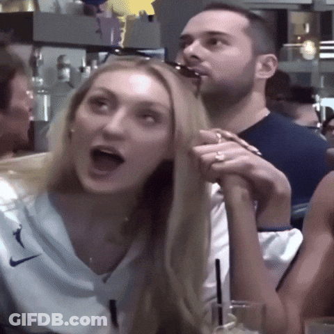 Man And Woman Sitting At Table With Mouths Open GIF