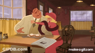 Man And Woman Sitting At Table With Newspaper GIF