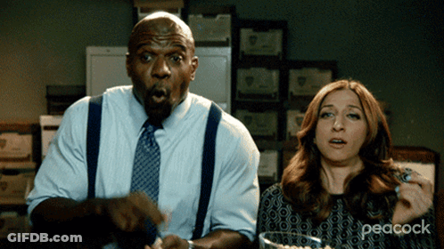 Man And Woman Sitting At Table With Peacock GIF
