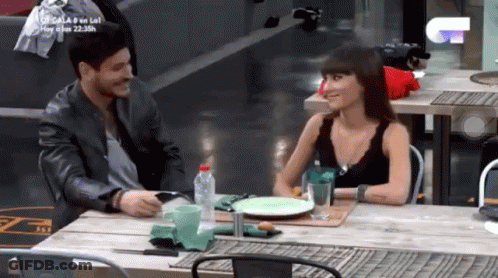 Man And Woman Sitting At Table With Water And Food GIF