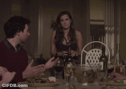 Man And Woman Sitting At Table With Wine Glasses GIF