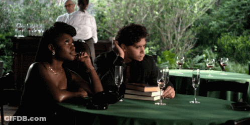 Man And Woman Sitting At Table With Wine Glasses GIF