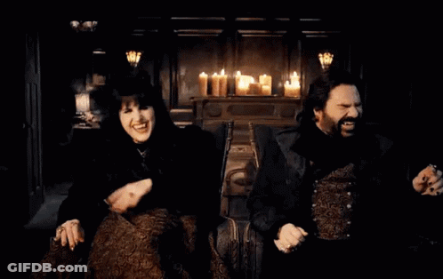 Man And Woman Sitting By Candles GIF