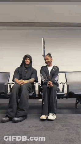 Man And Woman Sitting In Airport Waiting Area GIF