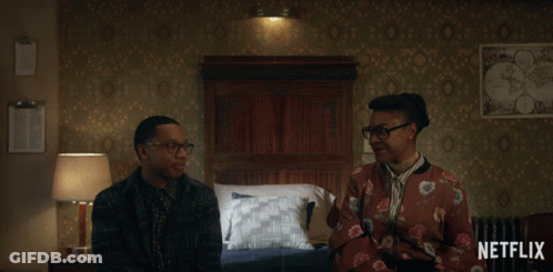 Man And Woman Sitting In Bedroom With Netflix Logo GIF