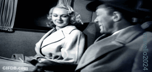 Man And Woman Sitting In Black And White Photo GIF