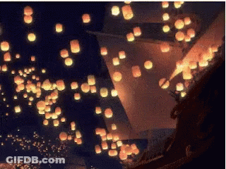 Man And Woman Sitting In Boat Looking At Lanterns GIF