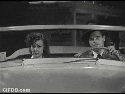 Man And Woman Sitting In Car Looking Out Window GIF