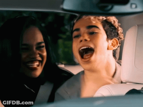 Man And Woman Sitting In Car With Mouths Open GIF