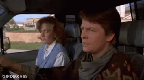Man And Woman Sitting In Car With Scarf Saying S GIF