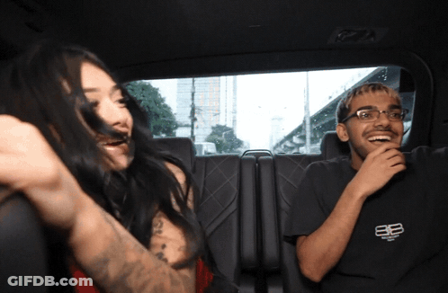 Man And Woman Sitting In Car Woman Covering Mouth GIF