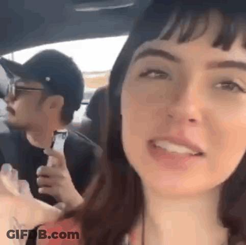 Man And Woman Sitting In Car Woman Holding Water GIF