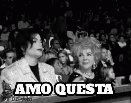 Man And Woman Sitting In Crowd GIF