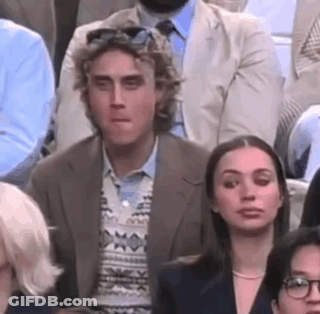 Man And Woman Sitting In Crowd GIF