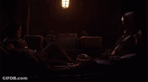 Man And Woman Sitting In Dark Room GIF