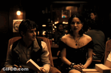 Man And Woman Sitting In Dark Room Man Wearing Carhartt Vest GIF