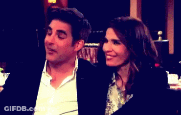 Man And Woman Sitting In Dark Room GIF