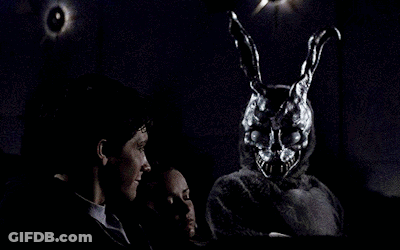Man And Woman Sitting In Dark Room With Rabbit Mask GIF