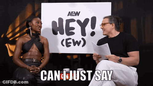 Man And Woman Sitting In Front Of Hey Ew Sign GIF