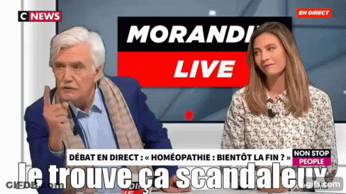 Man And Woman Sitting In Front Of Morandi Live Screen GIF