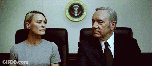Man And Woman Sitting In Front Of President Seal GIF