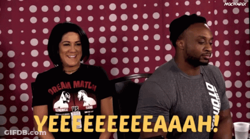 Man And Woman Sitting In Front Of Red And White Polka Dot Background GIF