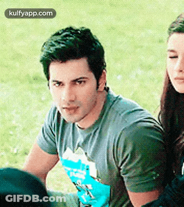 Man And Woman Sitting In Grass GIF