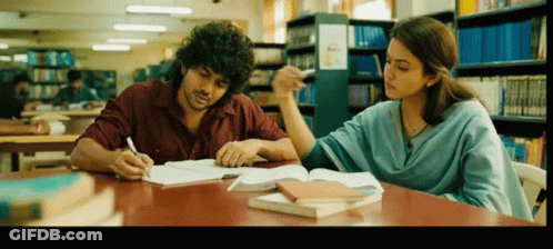 Man And Woman Sitting In Library GIF