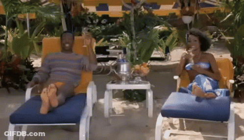Man And Woman Sitting In Lounge Chairs GIF