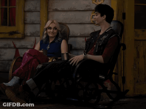 Man And Woman Sitting In Rocking Chairs Outside Building GIF