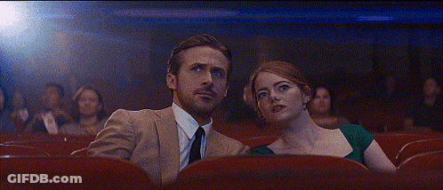 Man And Woman Sitting In Theater GIF