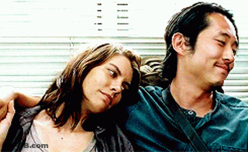 Man And Woman Sitting Looking At Camera GIF