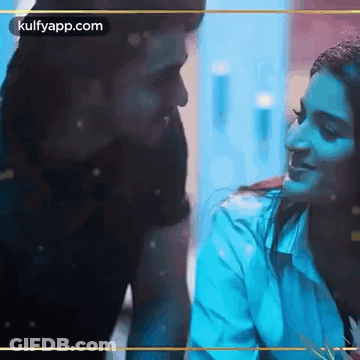 Man And Woman Sitting Looking At Each Other GIF
