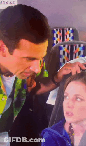 Man And Woman Sitting Near No Smoking Sign GIF