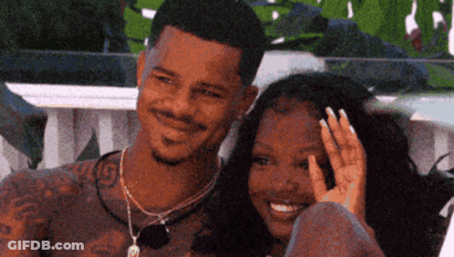 Man And Woman Sitting Next To Each Other Smiling GIF