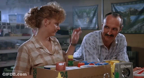Man And Woman Sitting Next To Explorer Box GIF