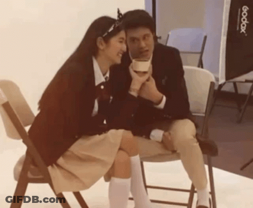 Man And Woman Sitting Next To Godox Light GIF