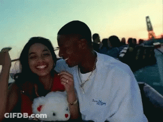 Man And Woman Sitting Next To Hello Kitty GIF