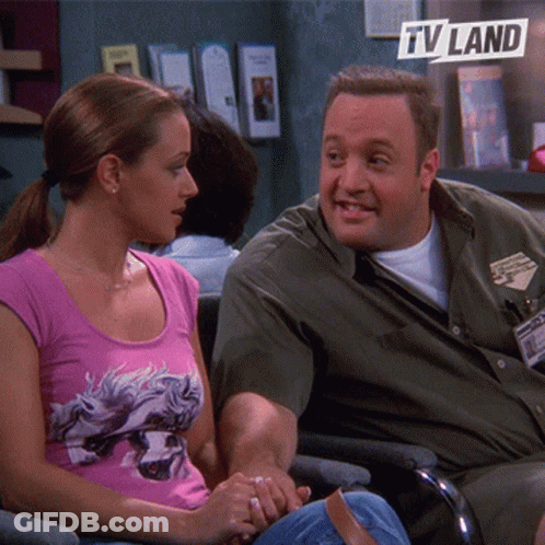 Man And Woman Sitting Next To TV Land Logo GIF