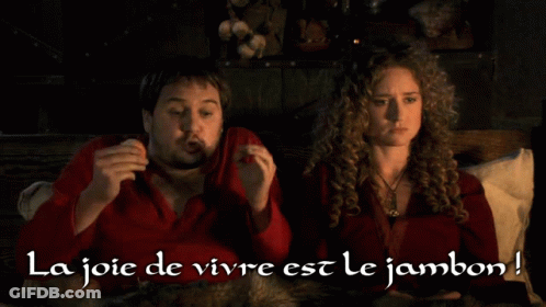 Man And Woman Sitting On Bed La Joie De Vivre Est Le Jambon GIF
