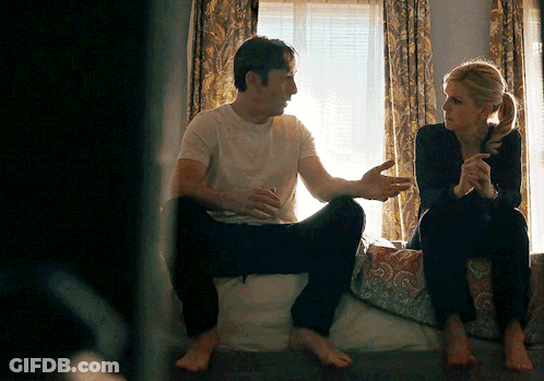 Man And Woman Sitting On Bed Talking GIF
