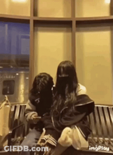 Man And Woman Sitting On Bench GIF