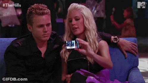 Man And Woman Sitting On Blue Couch GIF