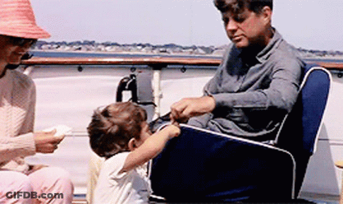 Man And Woman Sitting On Boat With Child GIF