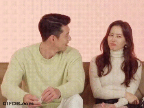 Man And Woman Sitting On Couch GIF