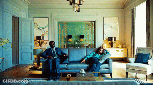 Man And Woman Sitting On Couch GIF