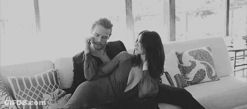 Man And Woman Sitting On Couch GIF