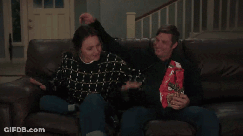 Man And Woman Sitting On Couch Eating Doritos GIF