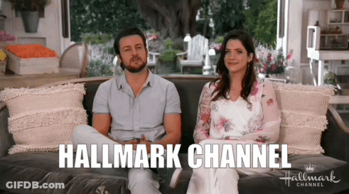 Man And Woman Sitting On Couch Hallmark Channel GIF